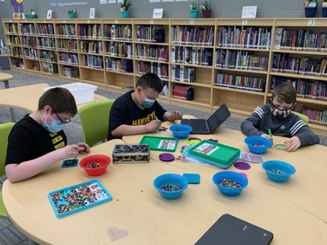 Students create fuse bead designs during makerspace rotations.